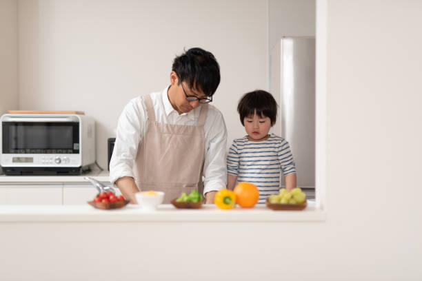 istock Father cooking in kitchen with his son 1138635350