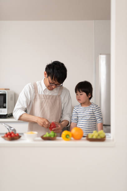 istock Father cooking in kitchen with his son 1138635419