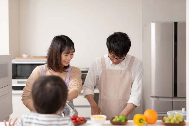 istock Wife and husband cooking together in kitchen 1138635741