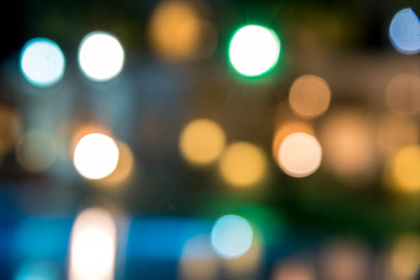 istock blurred night background, colored lights, water and buildings in defocus 1138635848