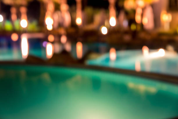 istock blurred night background, colored lights, water and buildings in defocus 1138636015