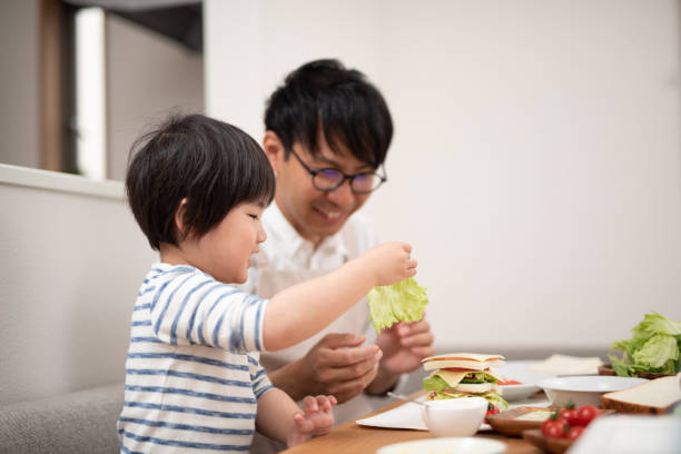 istock Father and son cooking sandwich 1138636940