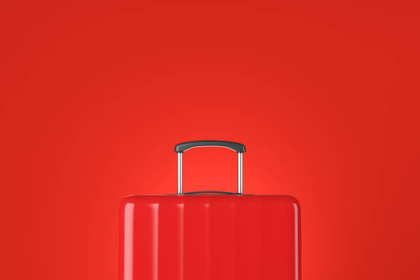 istock Red suitcase close up over red 1138636941