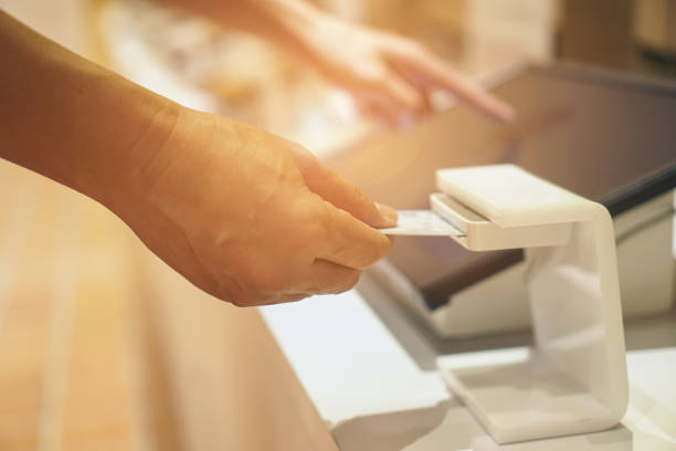 istock man person inserting card into scanner 1138637242