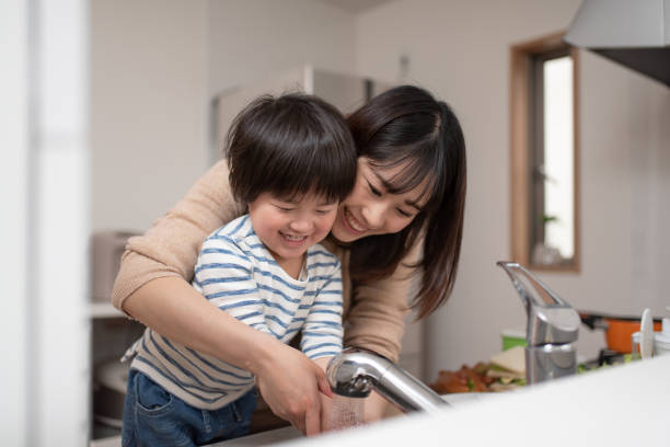 istock Mother teaching child how to wash hands 1138637552