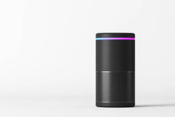 Voice controlled smart speaker standing over white background. Concept of technology and electronics. 3d rendering mock up