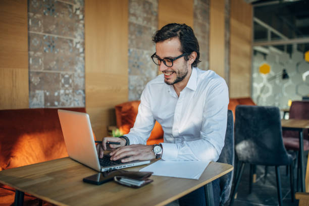 istock Businessman working on laptop in cafe 1138638024