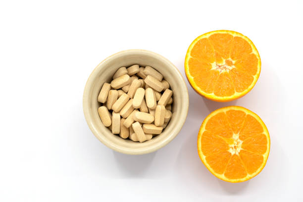 pot of vitamin c tablets - vitamin a letter a food orange imagens e fotografias de stock