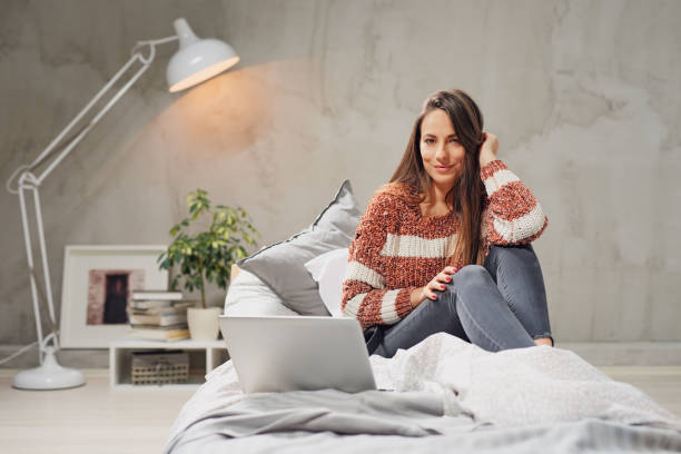 istock Woman using laptop in bedroom. 1138638967