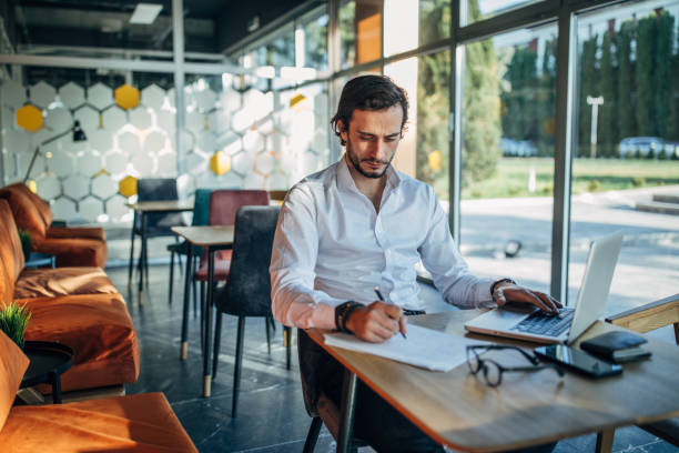 istock Man working on laptop in cafe 1138639396