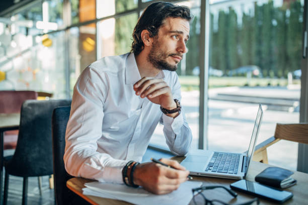 istock Man working on laptop in cafe 1138639439