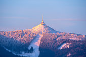 Jested Mountain and Jested Ski Resort in morning sunrise time. Clear sky and freezy winter time mood. Liberec, Czech Republic