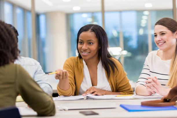 istock Beautiful female college student studies with friends 1138642606