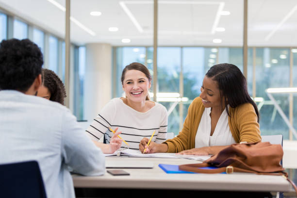 istock Smiling college friends study together 1138642652