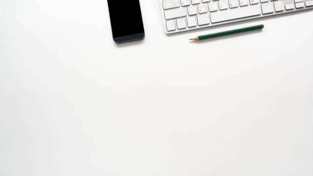 istock Office desk table with  keyboard and smart phone Top view copy space 1138642934