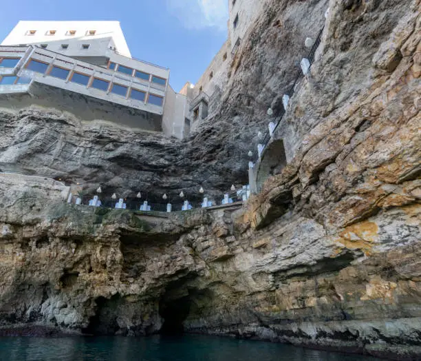 POLIGNANO, ITALY - 16 AUg 2016: The seafront entrance of Grotta Palazzese, a natural sea cave now part of a high end restaurant, in Polignano a Mare, Apulia, Italy