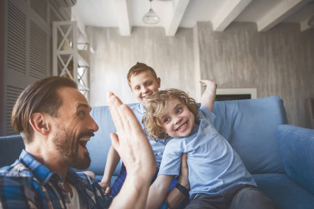 istock Glad kids having fun with positive parent 1138645258