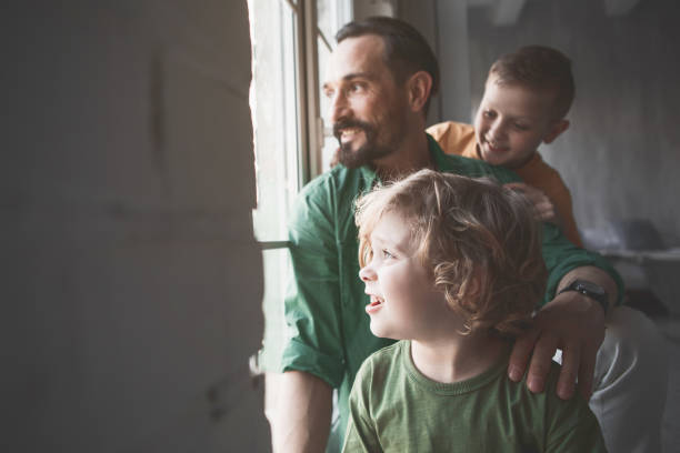 istock Cheerful parent and sons watching at street 1138645320