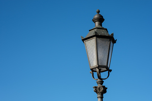 Vintage iron cast street lamp with blue sky