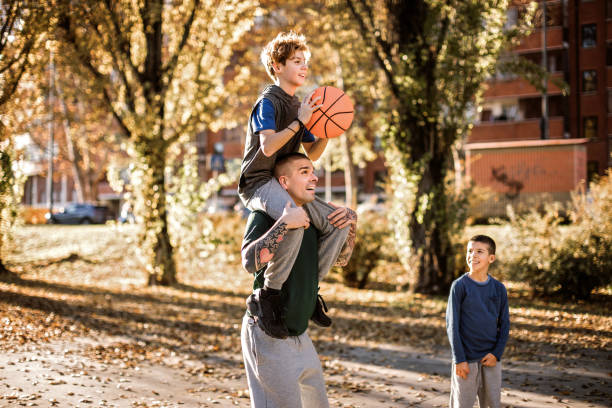 istock Father helping son to make a score in basketball 1138651575