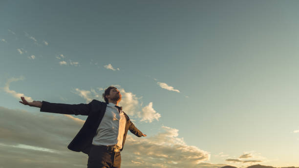 istock Young businessman relaxing under evening sky 1138652677