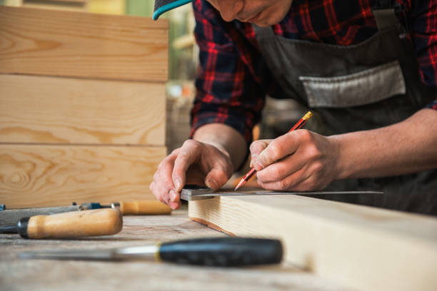 istock The worker makes measurements of a wooden board 1138653208