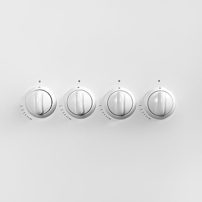 Four white gas stove control knobs. Minimal concept. Copy space for your text or design.