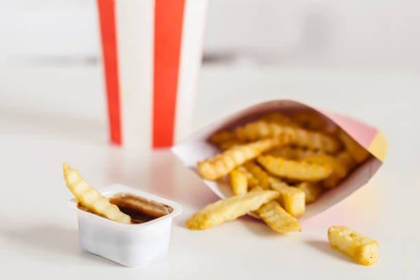 istock French fries and cola on a white background, selective focus 1138653566