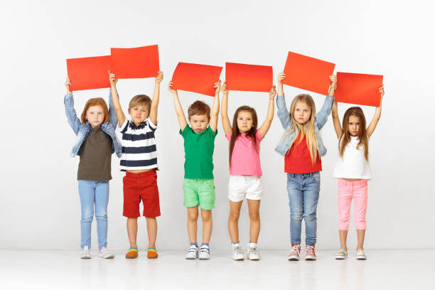 istock Group of children with red banners isolated in white 1138653587
