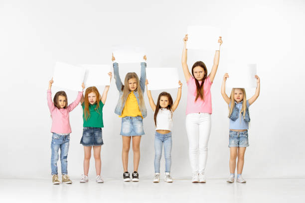 istock Group of children with a white banners isolated in white 1138653683