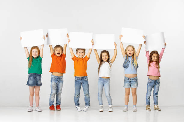 istock Group of children with a white banners isolated in white 1138653697