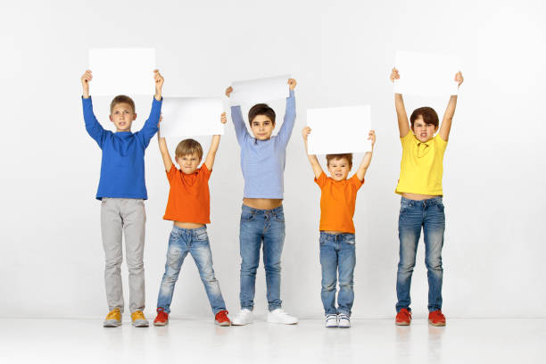 istock Group of children with a white banners isolated in white 1138653698