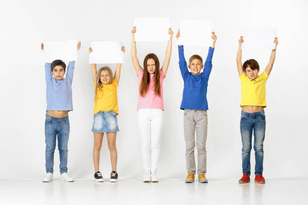 istock Group of children with a white banners isolated in white 1138653717