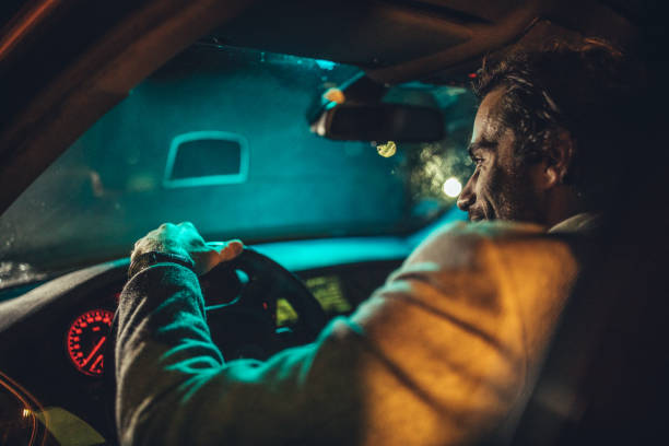 istock Man Driving A Car In Night 1138654067
