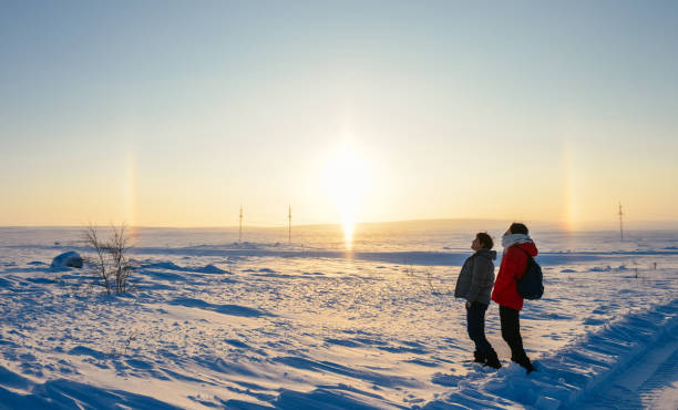 istock Asian couple looking at rainbow and sun in Arctic 1138655168