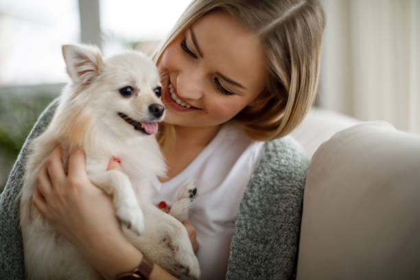 istock Woman cuddling with her dog 1138655184