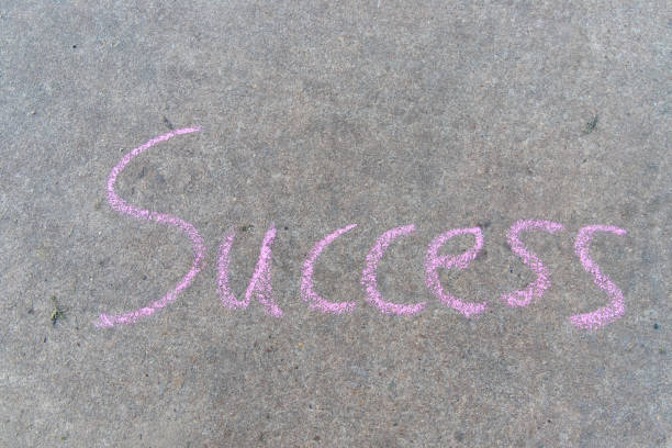 istock Success written with pink sidewalk chalk 1138655269