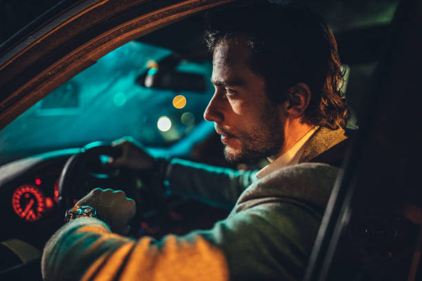 istock Businessman Driving A Car In Night 1138656987