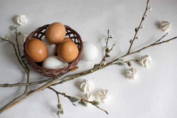 istock Nest with white and brown chicken eggs and quail eggs, willow branches 1138657407