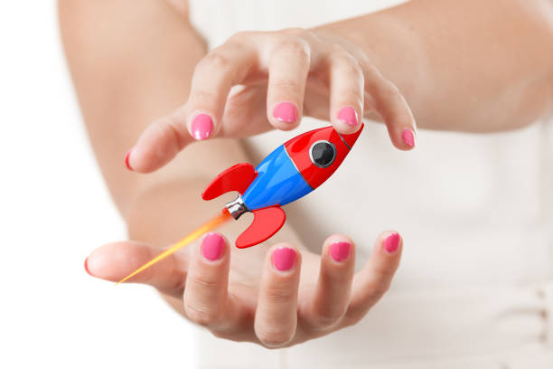 istock Two Woman Hands Protecting Modern Cartoon Rocket. 3d Rendering 1138657564