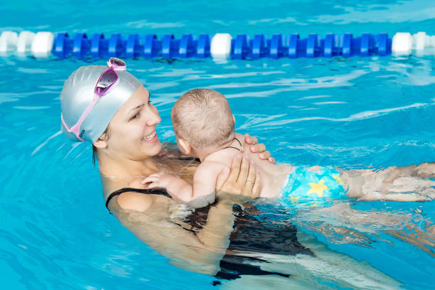 istock Professional swimming lessons in pool for children 1138657786