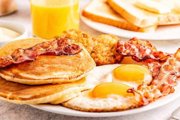 istock Healthy Full American Breakfast with Eggs Bacon Pancakes and Latkes 1138664264