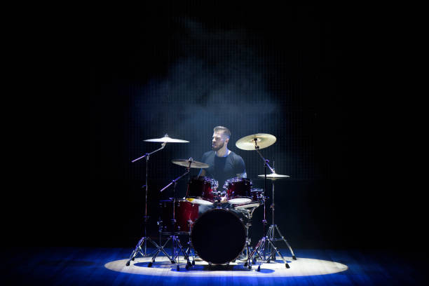 istock Silhouette drummer on stage. Dark background, smoke spotlights 1138666655