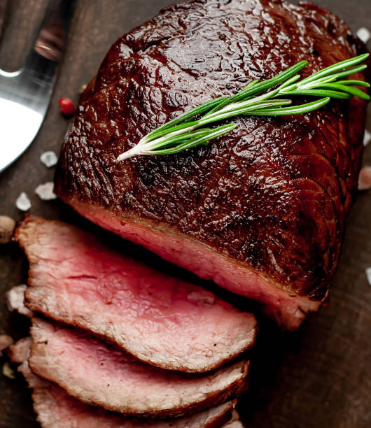 istock beef steak on a cutting board. on a dark concrete background 1138666762