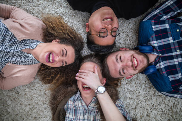 istock Smiling cheerful young lying on the carpet 1138669302