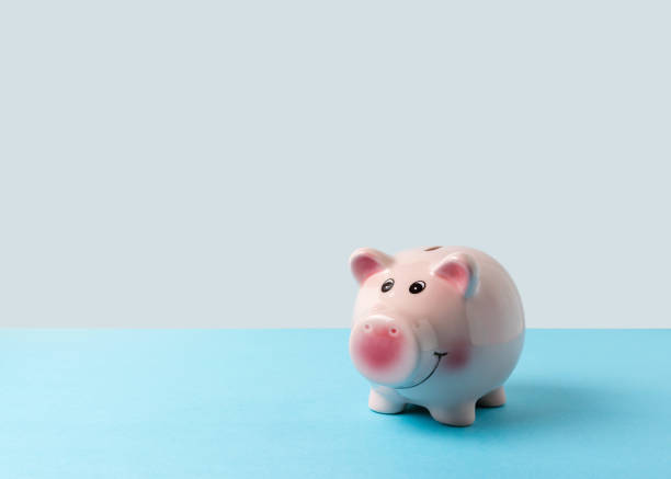 istock Piggy bank on blue table. Saving money concept. 1138670757