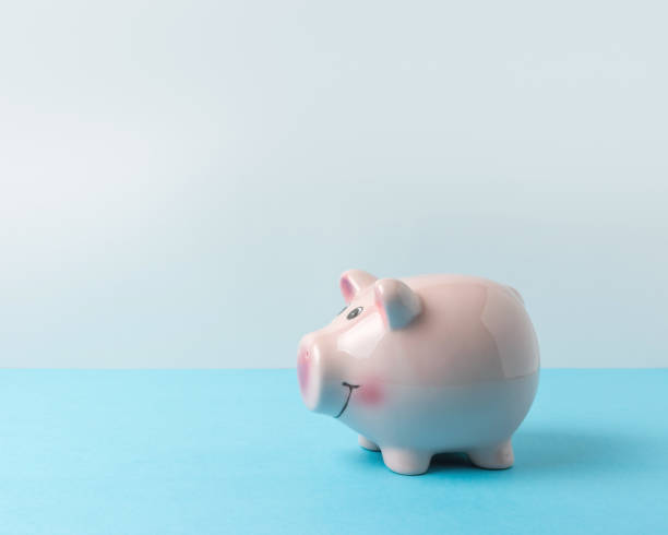 istock Piggy bank on blue table. Saving money concept. 1138670761