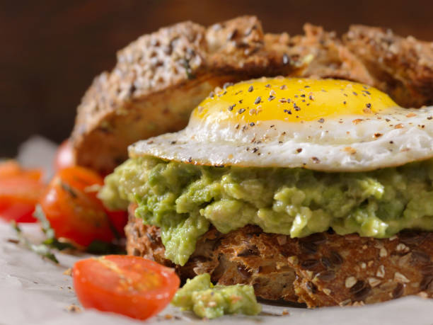 istock Creamy Avocado Sandwich with a Fried Egg and Tomatoes 1138670875