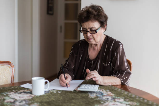 istock Senior woman is doing finances at home. 1138671091