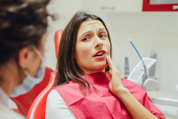 close-up portrait of a sad young girl with a painful tooth, a doctor in office chairs, an isolated dentist office background clinic. - dental drill dental equipment dental hygiene drill imagens e fotografias de stock